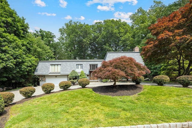 15 Dunmore Rd, New City, NY 10956 - view of property featuring mansard roof, a front yard, a chimney, and driveway