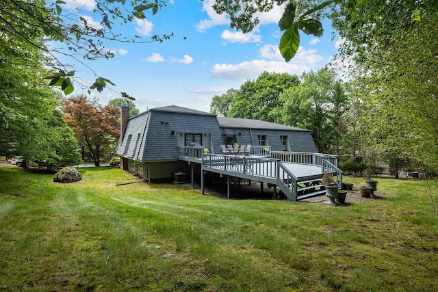 15 Dunmore Rd, New City, NY 10956 - rear view of house with a gambrel roof, a yard, a wooden deck, and a chimney