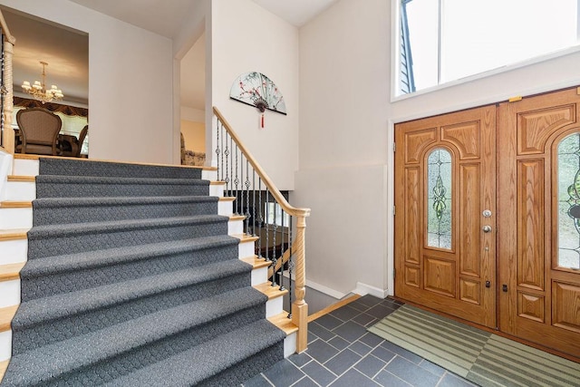 15 Dunmore Rd, New City, NY 10956 - entryway with stairway, plenty of natural light, dark tile patterned floors, a chandelier, and a high ceiling