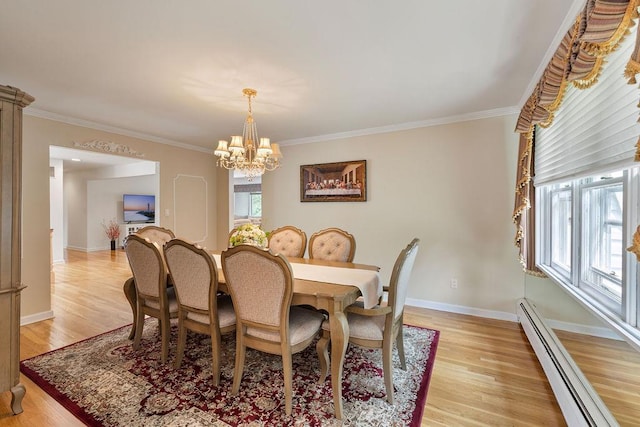 15 Dunmore Rd, New City, NY 10956 - dining area featuring a baseboard heating unit, a chandelier, ornamental molding, and light wood finished floors