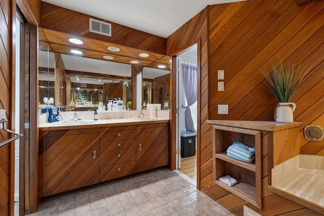 15 Dunmore Rd, New City, NY 10956 - full bathroom with double vanity, wood walls, and an enclosed shower