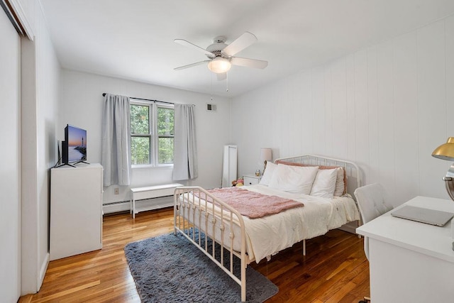 15 Dunmore Rd, New City, NY 10956 - bedroom with light wood-style floors, baseboard heating, and ceiling fan
