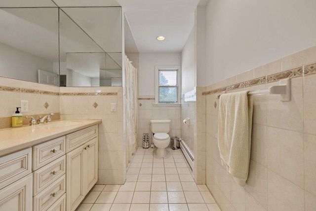15 Dunmore Rd, New City, NY 10956 - bathroom with tile walls, tile patterned flooring, baseboard heating, vanity, and a wainscoted wall