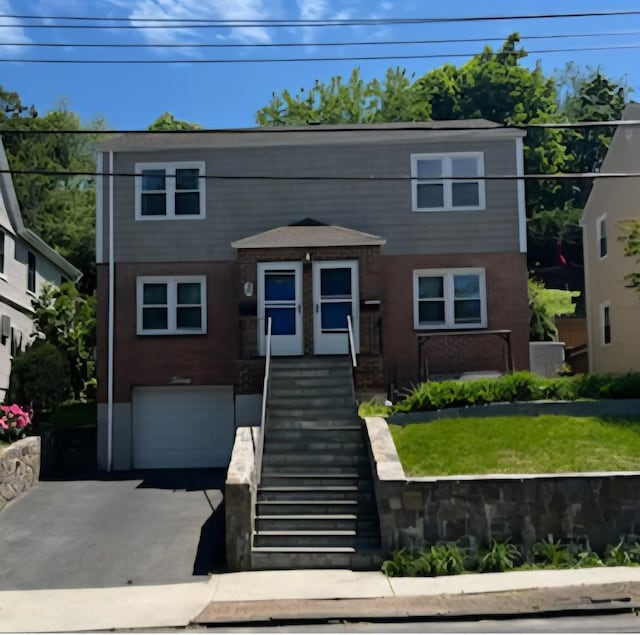 20 Oak Ave, Tuckahoe, NY 10707 - view of front facade featuring a garage, driveway, and stairway