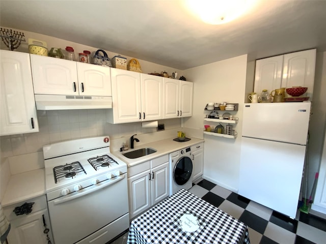 73-19 217th St Unit Nd, Oakland Gardens, NY 11364 - kitchen featuring white appliances, washer / clothes dryer, under cabinet range hood, dark flooring, and light countertops