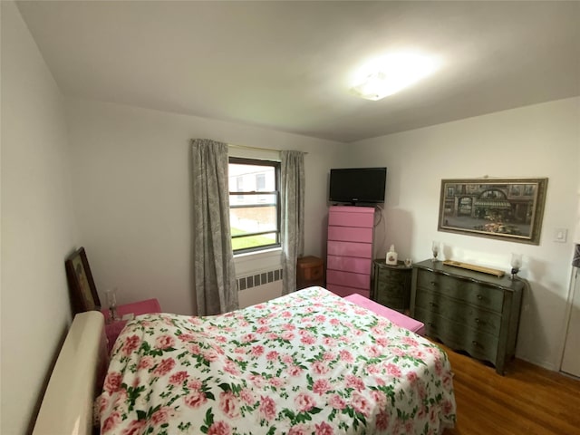 73-19 217th St Unit Nd, Oakland Gardens, NY 11364 - bedroom featuring radiator heating unit and wood finished floors