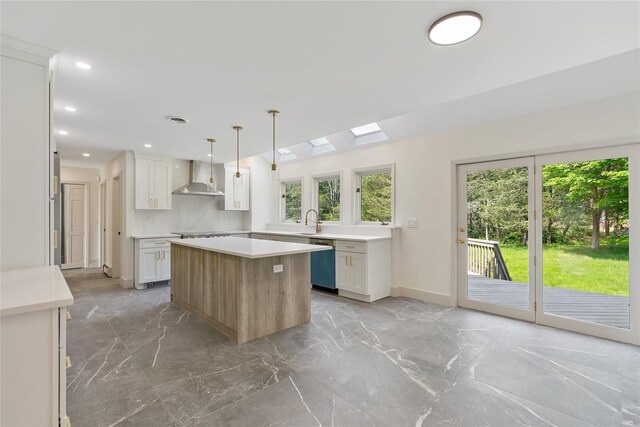 17 Royal Ct, Warwick, NY 10990 - kitchen featuring wall chimney range hood, stainless steel dishwasher, light marble finish flooring, light countertops, and recessed lighting