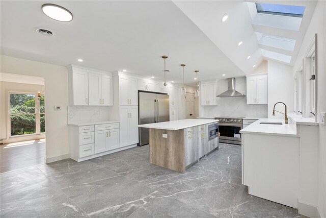 17 Royal Ct, Warwick, NY 10990 - kitchen with high quality appliances, wall chimney range hood, a skylight, decorative backsplash, and recessed lighting