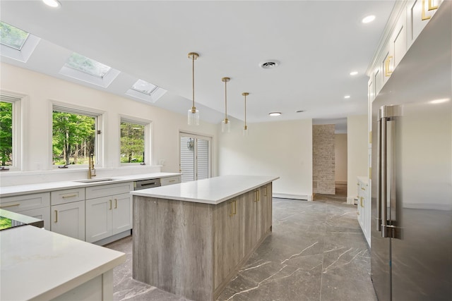17 Royal Ct, Warwick, NY 10990 - kitchen with appliances with stainless steel finishes, a skylight, a kitchen island, baseboard heating, and recessed lighting