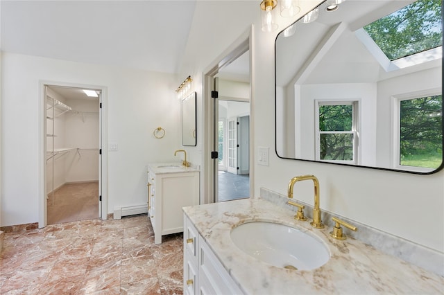 17 Royal Ct, Warwick, NY 10990 - full bath with baseboard heating, two vanities, a skylight, a spacious closet, and lofted ceiling