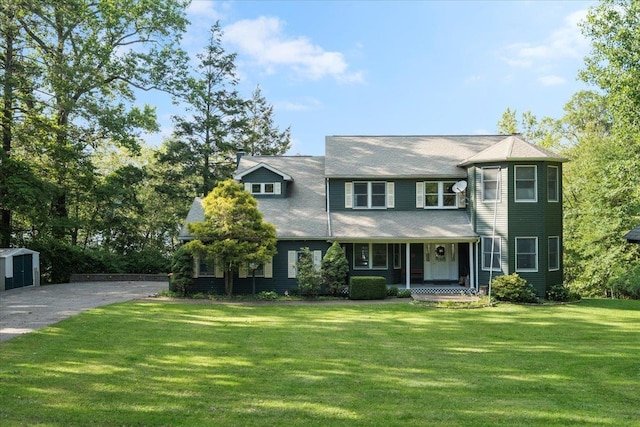 1034 Rte 292, Holmes, NY 12531 - victorian home featuring covered porch, a front yard, and a storage unit