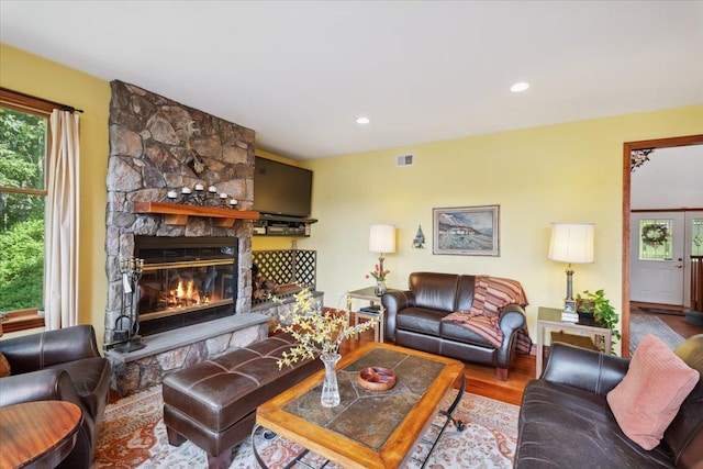 1034 Rte 292, Holmes, NY 12531 - living area with plenty of natural light, a stone fireplace, wood finished floors, and recessed lighting