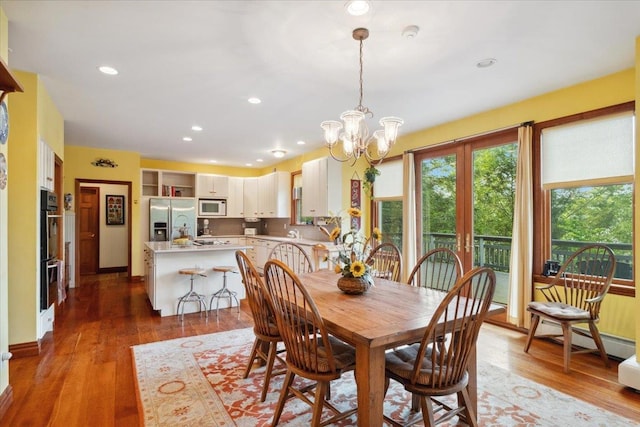 1034 Rte 292, Holmes, NY 12531 - dining area featuring a chandelier, wood finished floors, recessed lighting, and a baseboard heating unit