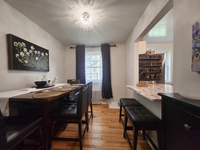64-15 Springfield Blvd Unit A, Oakland Gardens, NY 11364 - dining room featuring radiator heating unit, light wood-style flooring, and a chandelier