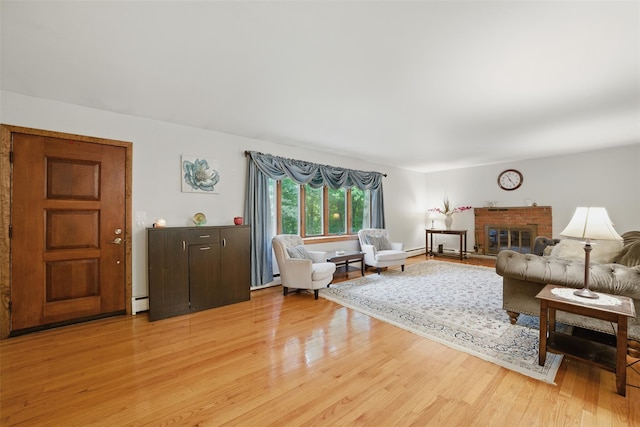99 Furnace Dock Rd, Croton-On-Hudson, NY 10520 - living room with light wood finished floors, a brick fireplace, and a baseboard heating unit