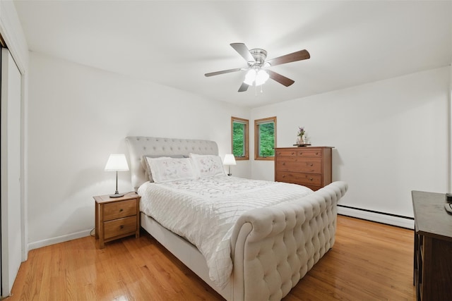 99 Furnace Dock Rd, Croton-On-Hudson, NY 10520 - bedroom featuring a baseboard heating unit, light wood-style flooring, a closet, baseboards, and a ceiling fan