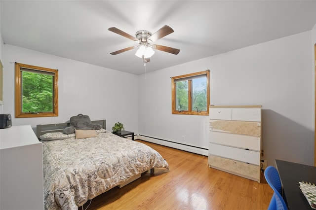 99 Furnace Dock Rd, Croton-On-Hudson, NY 10520 - bedroom with a baseboard heating unit, multiple windows, wood finished floors, and ceiling fan