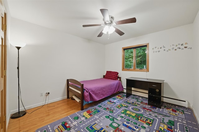 99 Furnace Dock Rd, Croton-On-Hudson, NY 10520 - bedroom featuring a baseboard heating unit, wood finished floors, baseboards, and ceiling fan