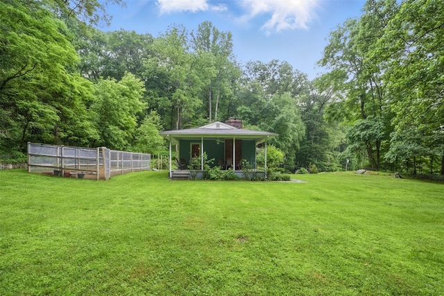 99 Furnace Dock Rd, Croton-On-Hudson, NY 10520 - view of green lawn with a greenhouse, an outbuilding, and a wooded view