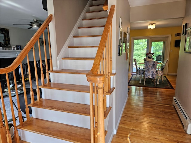 133 Lattintown Rd, Newburgh, NY 12550 - staircase featuring a baseboard radiator, wood finished floors, and a ceiling fan