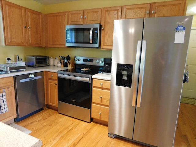 133 Lattintown Rd, Newburgh, NY 12550 - kitchen featuring appliances with stainless steel finishes, light wood-style flooring, and light countertops