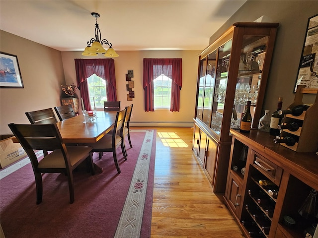 133 Lattintown Rd, Newburgh, NY 12550 - dining room featuring a baseboard radiator, light wood-style flooring, and a chandelier