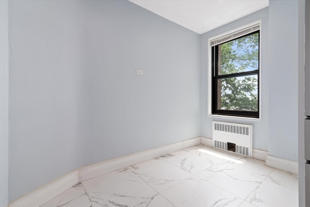 83-30 98th St Unit 5A, Woodhaven, NY 11421 - spare room with radiator heating unit, marble finish flooring, and baseboards