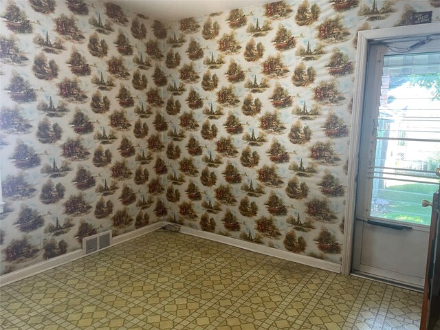 4 New Hyde Park Rd, New Hyde Park, NY 11040 - empty room with plenty of natural light and wallpapered walls