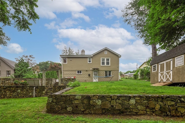 33 Hollowbrook Ct N, Cortlandt Manor, NY 10567 - rear view of house with a storage unit, a chimney, and a yard
