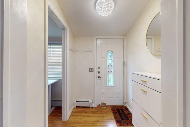 33 Hollowbrook Ct N, Cortlandt Manor, NY 10567 - entryway with light wood finished floors and a baseboard radiator