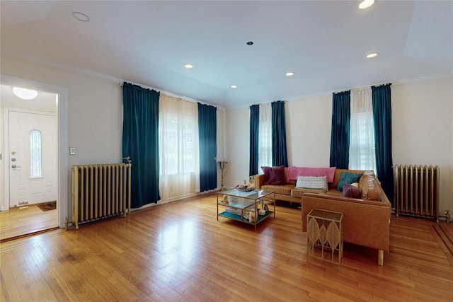 33 Hollowbrook Ct N, Cortlandt Manor, NY 10567 - living area with radiator heating unit, wood finished floors, ornamental molding, and recessed lighting