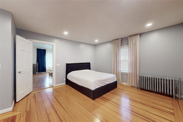 33 Hollowbrook Ct N, Cortlandt Manor, NY 10567 - bedroom featuring radiator heating unit, light wood-type flooring, and recessed lighting