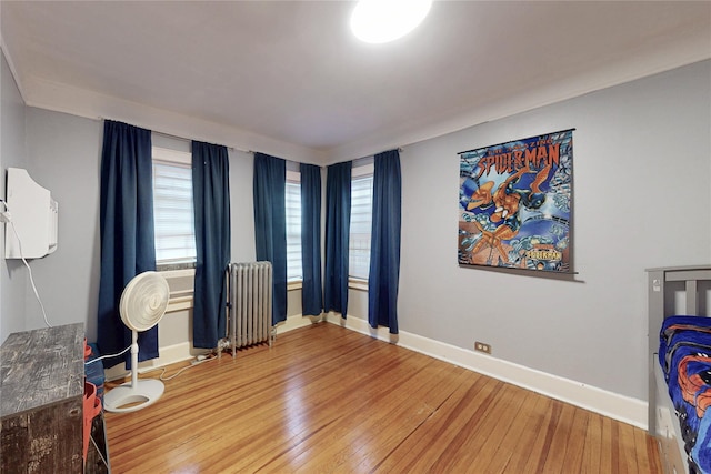 33 Hollowbrook Ct N, Cortlandt Manor, NY 10567 - unfurnished bedroom with radiator, hardwood / wood-style floors, and multiple windows