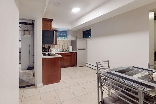 33 Hollowbrook Ct N, Cortlandt Manor, NY 10567 - kitchen with freestanding refrigerator, light countertops, tasteful backsplash, and light tile patterned flooring
