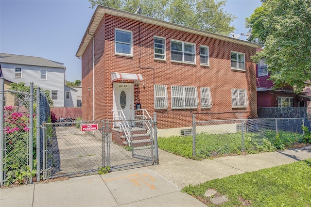 39-32 54th St, Woodside, NY 11377 - view of front of home with a fenced front yard, a gate, and brick siding