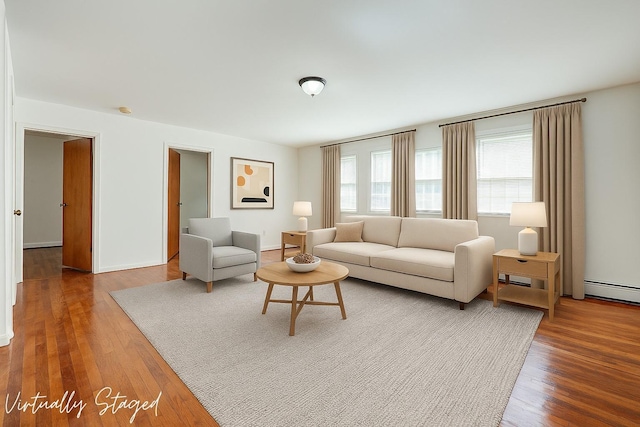 39-32 54th St, Woodside, NY 11377 - living room with wood finished floors and baseboard heating