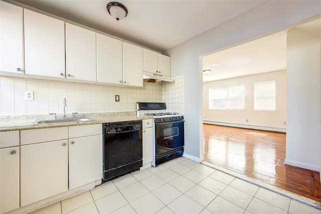 39-32 54th St, Woodside, NY 11377 - kitchen with black appliances, baseboard heating, a sink, under cabinet range hood, and decorative backsplash