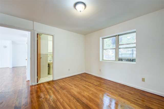 39-32 54th St, Woodside, NY 11377 - spare room featuring wood finished floors and baseboards