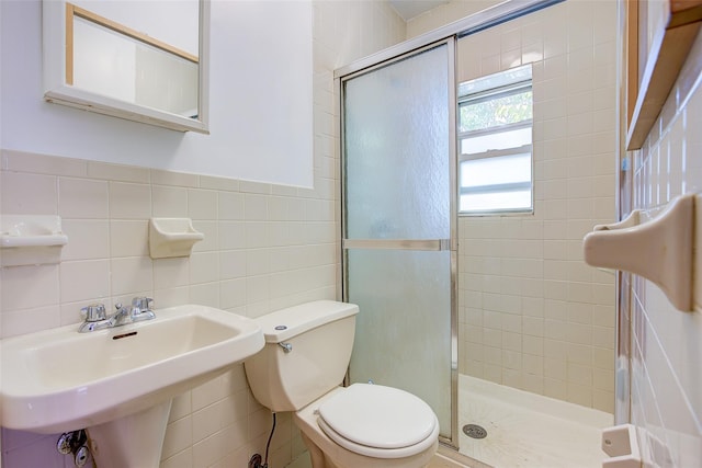 39-32 54th St, Woodside, NY 11377 - full bath with tile walls, toilet, a shower stall, and a sink