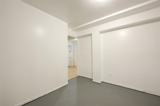 39-32 54th St, Woodside, NY 11377 - empty room with concrete flooring and baseboards