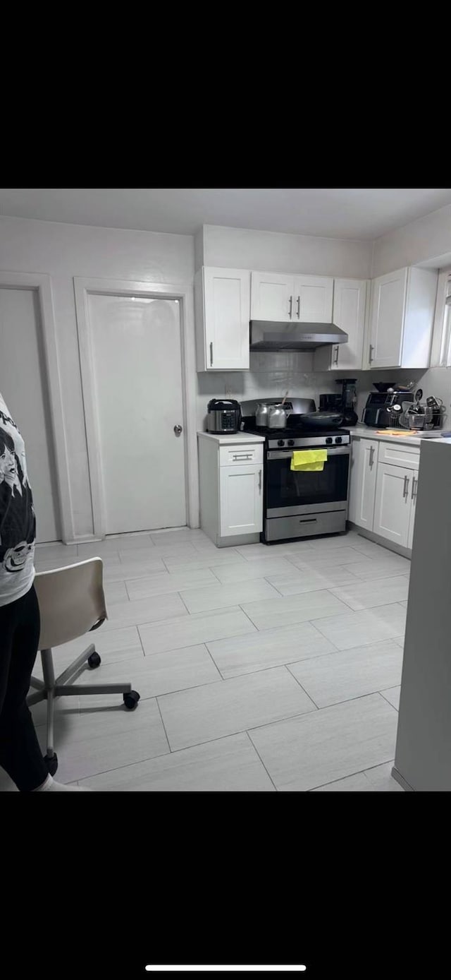 125-03 13th Ave, College Point, NY 11356 - kitchen featuring stainless steel range with gas cooktop, under cabinet range hood, and white cabinetry