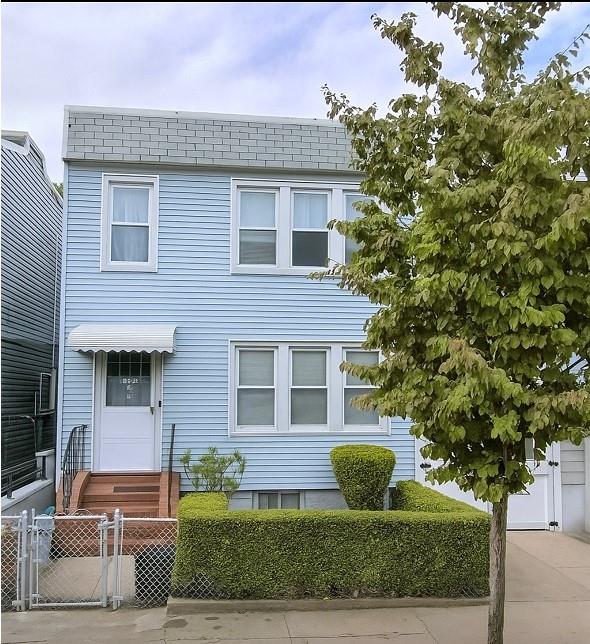 125-03 13th Ave, College Point, NY 11356 - view of front of house with a fenced front yard, entry steps, and a gate