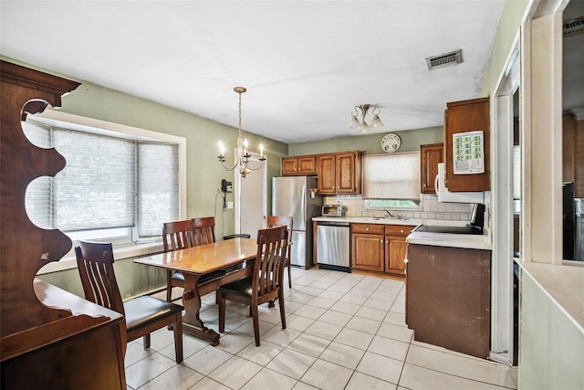 10 Marlan Ct, Smithtown, NY 11787 - dining space with a chandelier and light tile patterned flooring