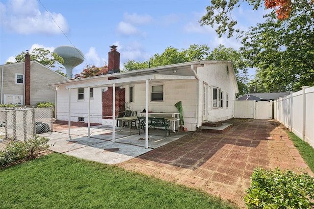 10 Marlan Ct, Smithtown, NY 11787 - rear view of house featuring a patio area, a fenced backyard, a gate, and a chimney
