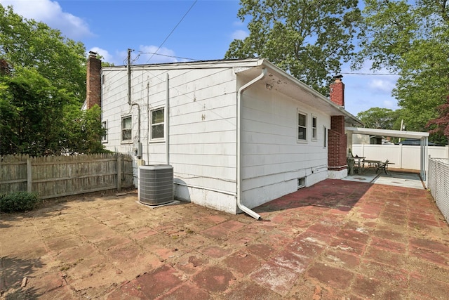10 Marlan Ct, Smithtown, NY 11787 - rear view of property with a chimney, a patio, and a fenced backyard