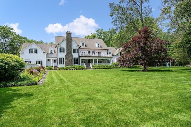 21 Dorann Rd, Purchase, NY 10577 - back of property with a chimney, a porch, and a yard