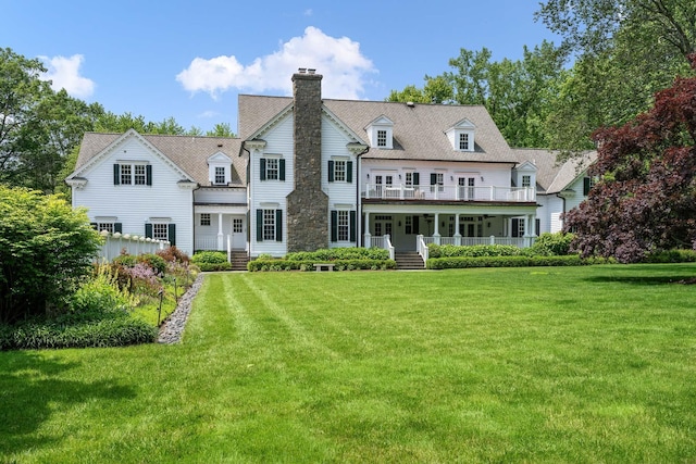 21 Dorann Rd, Purchase, NY 10577 - rear view of house featuring a chimney, a porch, a yard, and a balcony