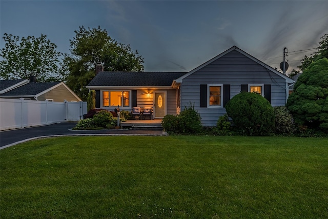 10 Bradish Ln, Babylon, NY 11702 - view of front facade featuring a chimney, driveway, and a porch