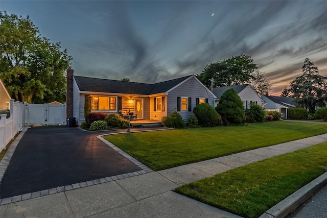 10 Bradish Ln, Babylon, NY 11702 - single story home with a gate, asphalt driveway, a chimney, and covered porch