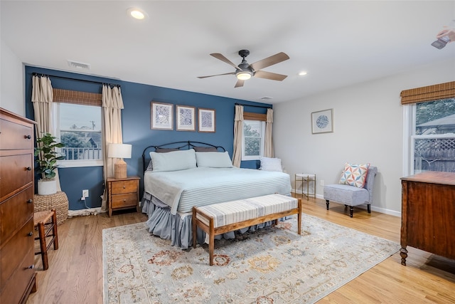 10 Bradish Ln, Babylon, NY 11702 - bedroom with multiple windows, light wood finished floors, and recessed lighting